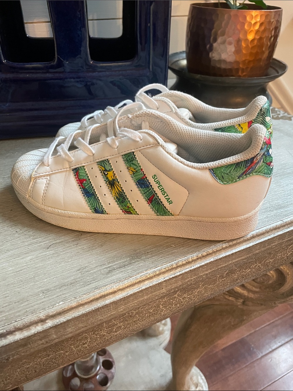 adidas Kids Superstar clamshells in White with floral accents.